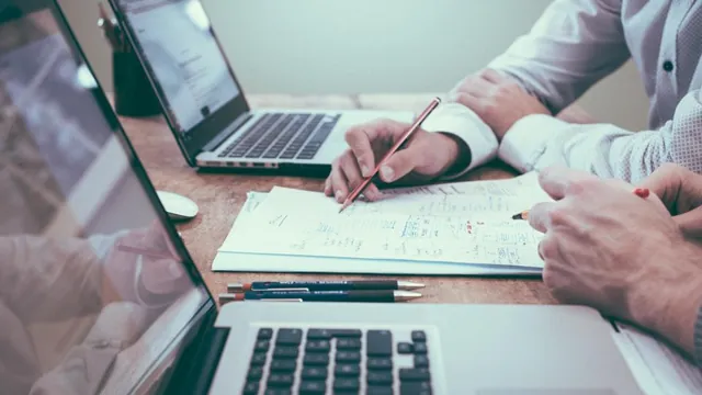Osoba pisząca tekst na laptopie z pomocą asystenta AI